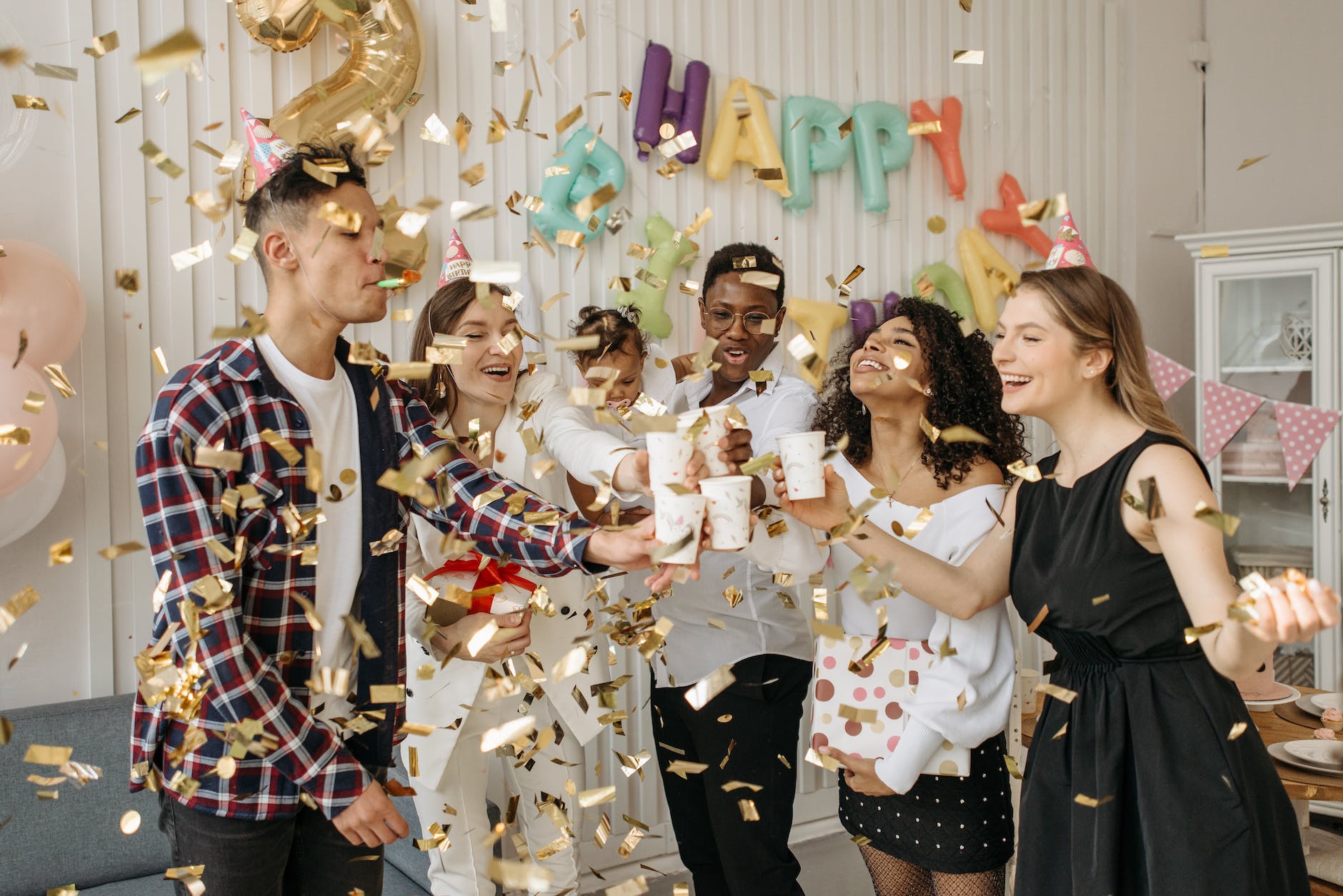 family and group of friends celebrating a child s birthday