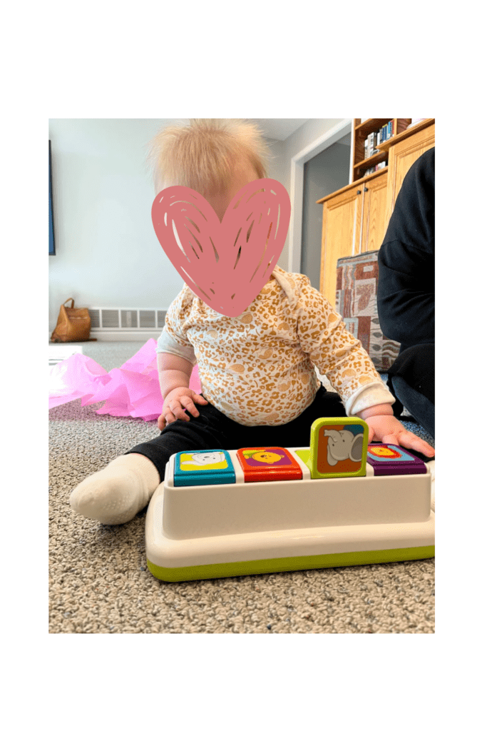 heart over baby face with pop up toy