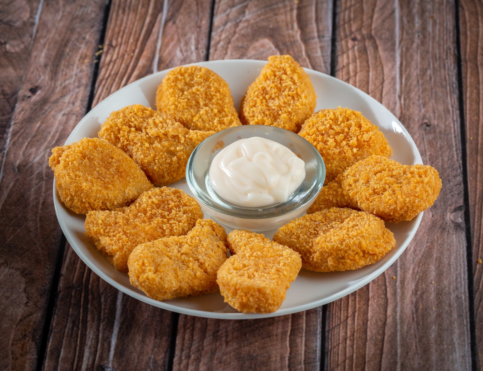 chicken nuggets lying on table with mayo