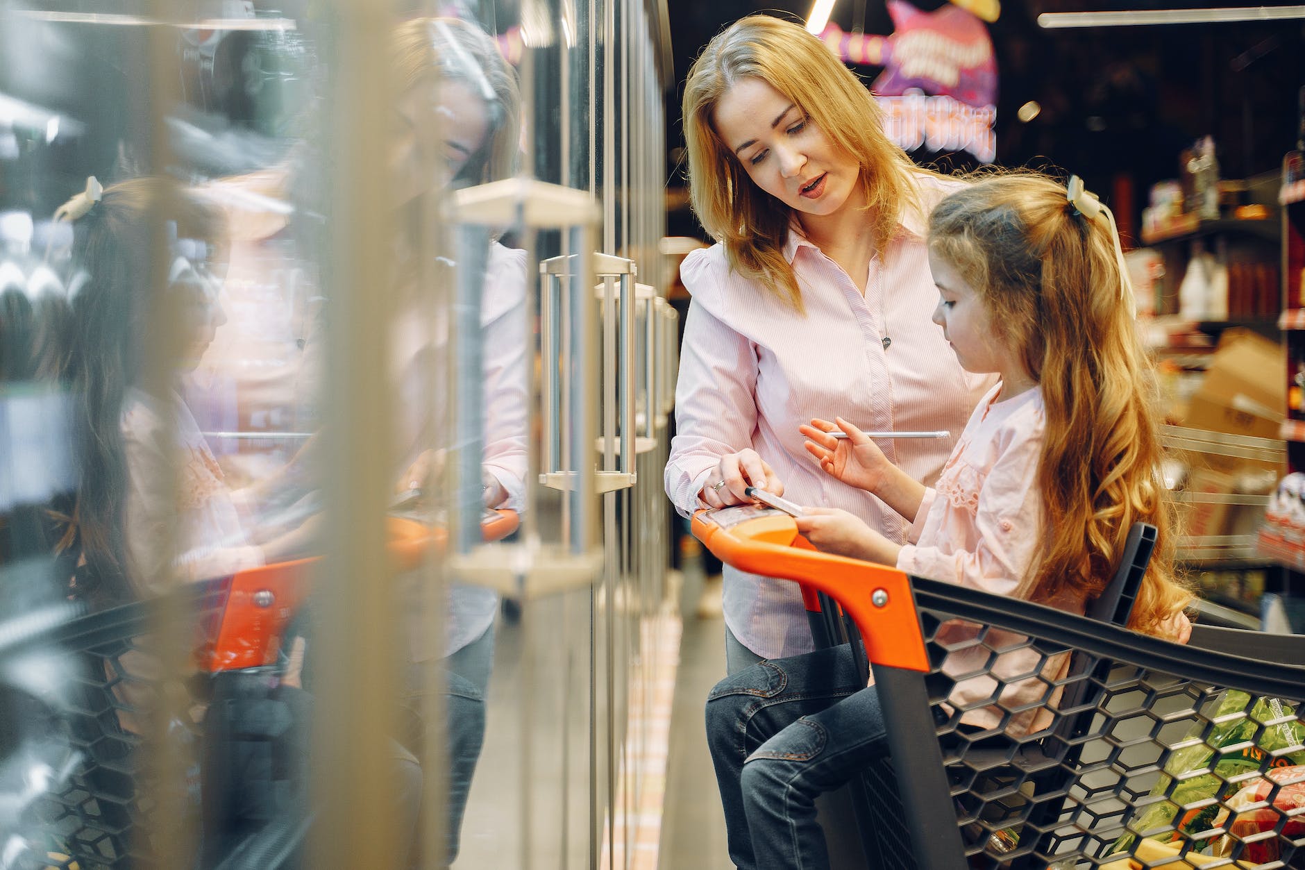 mother and daughter checking their grocery list