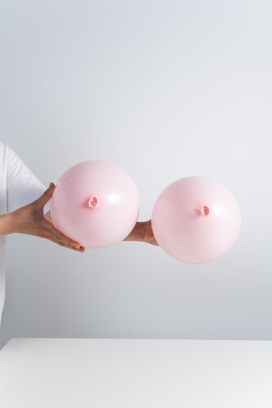 a person holding pink balloons