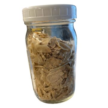 Dried sourdough starter flakes in a ball mason jar with a lid