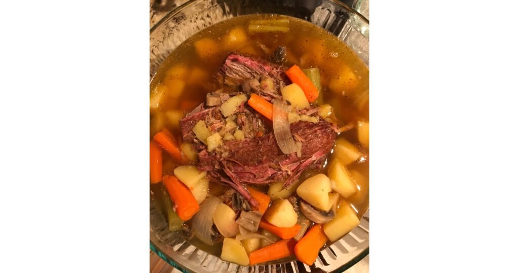 Stew with carrots, celery, beef, potatoes, onions and mushrooms.