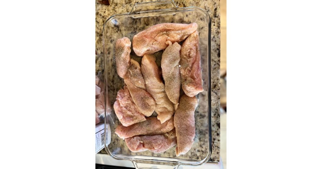 Raw chicken breasts with salt and pepper.