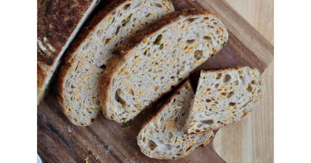 Three slices of jalapeño cheddar sourdough bread.