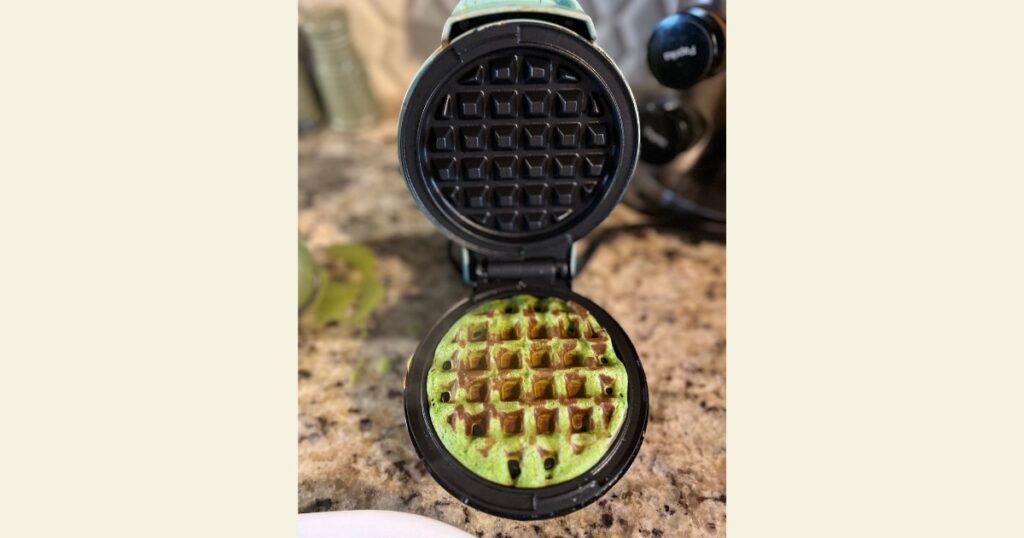 Finished green waffle in waffle iron