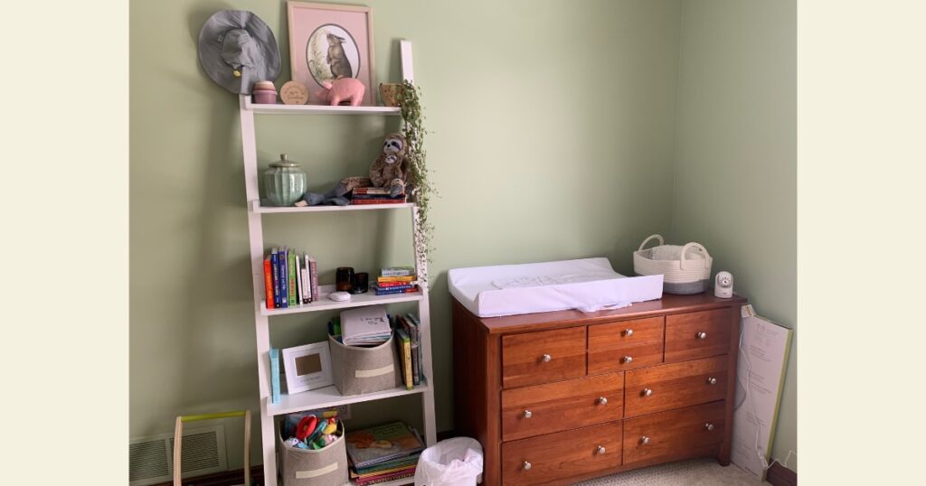 Green nursery with diaper changing table.