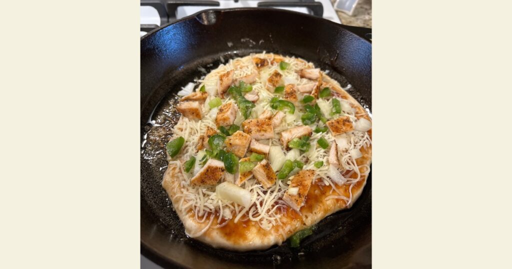 Sourdough pizza with toppings in a cast iron skillet