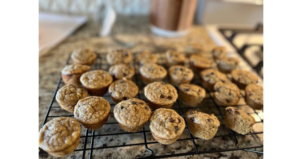 sourdough banana muffins on cooling rack side angle