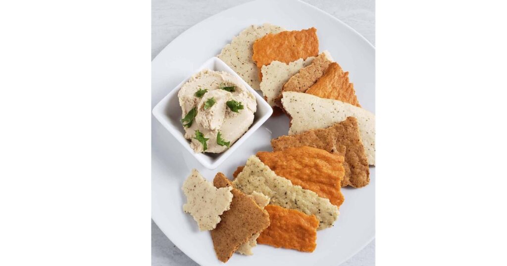 sourdough cheese crackers on a plate with dip