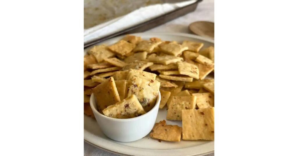 stack of sourdough fire chili crackers surrounding a small bowl