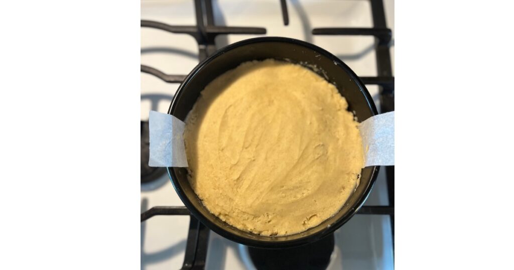 uncooked sourdough sugar cookie crust in a 9" cake pan