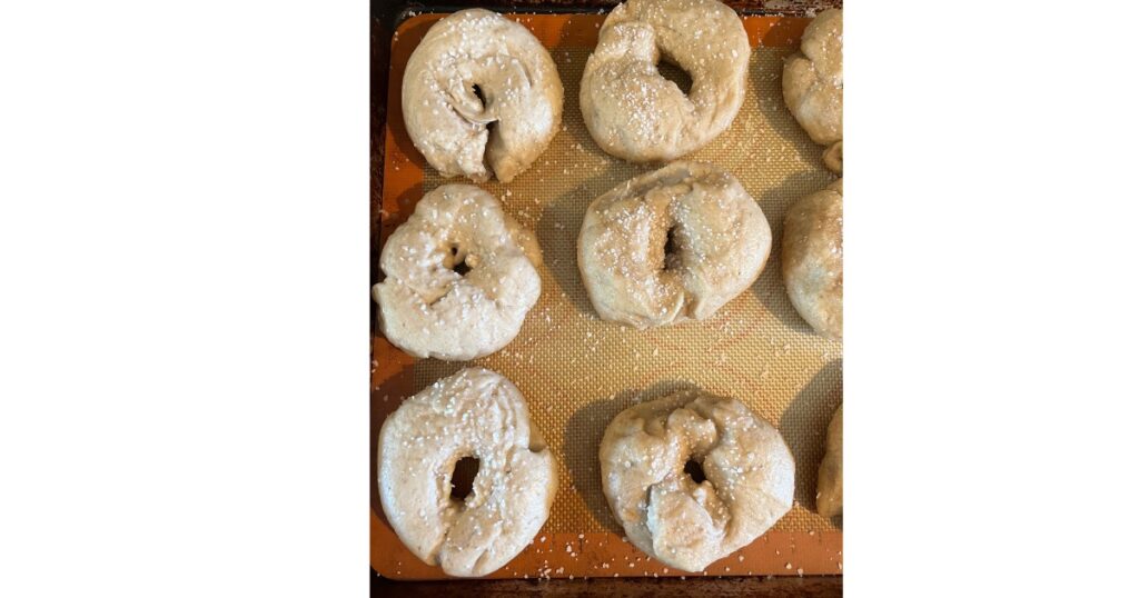 precooked bagels on a sheet pan