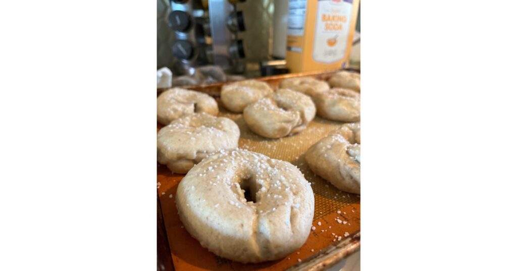 bagels on a sheet pan with baking soda in the background