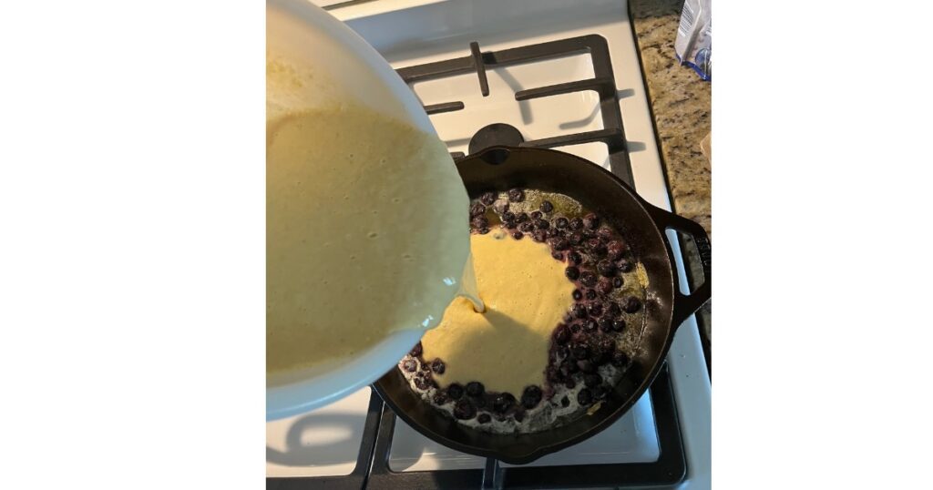 sourdough dutch baby poured over blueberries