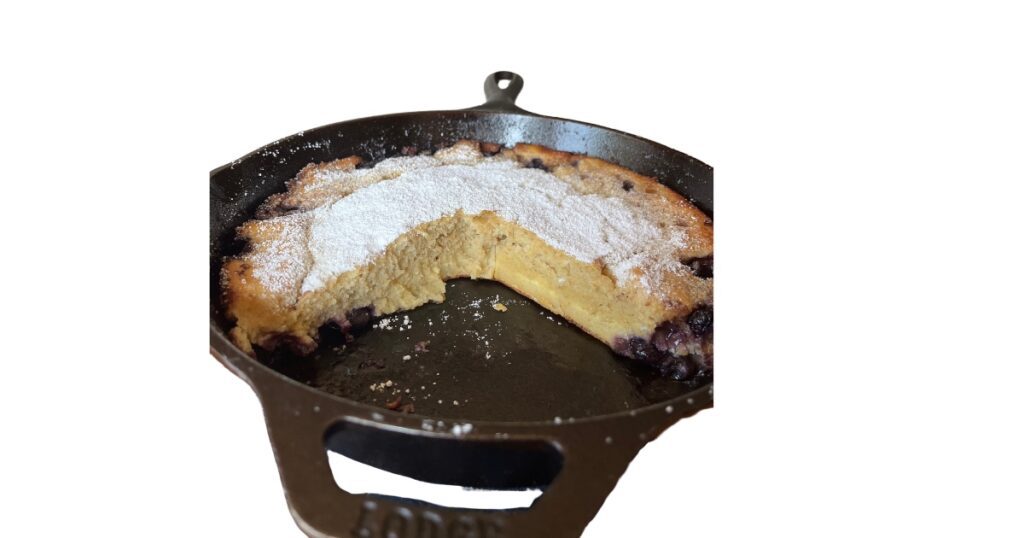 sourdough dutch baby side view in cast iron skillet