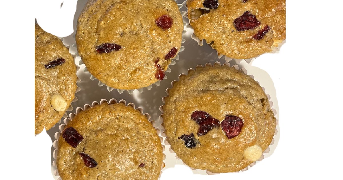 close up of muffins with white chocolate and dried cranberries on top