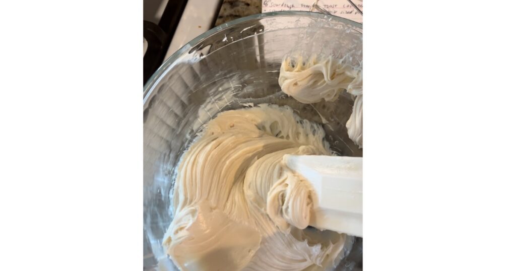 homemade cream cheese frosting on a white spatula