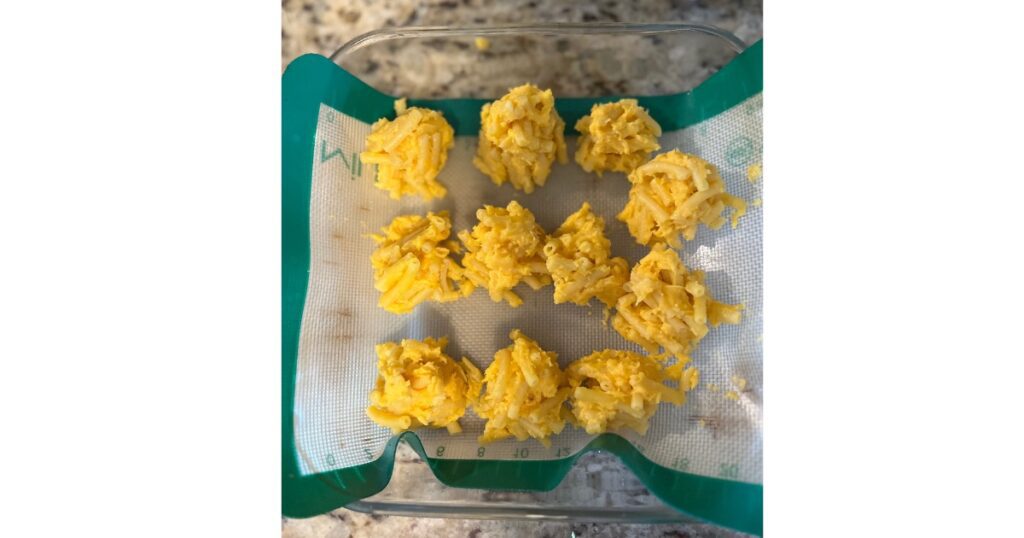 mac and cheese balls on green cooling mat