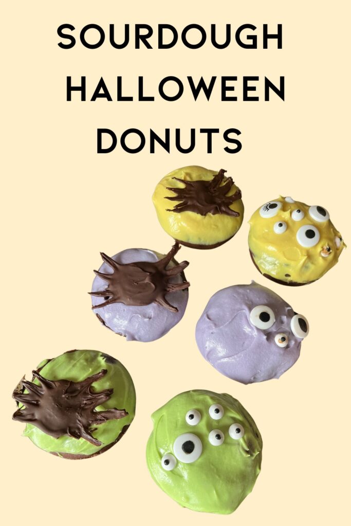 Six green, purple and yellow donuts with edible eyeballs and chocolate spiders