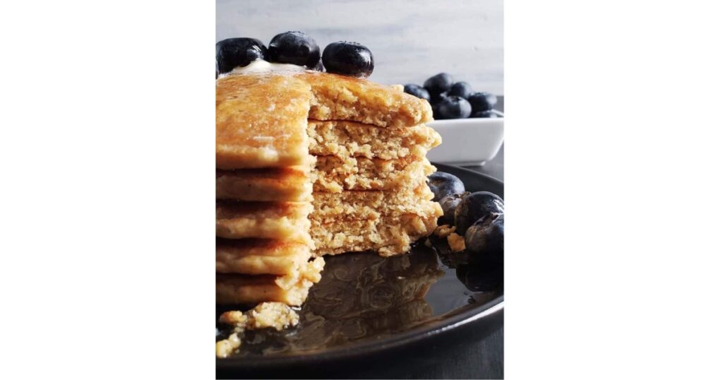 pancake stack with cut out of center. Blueberries on top.