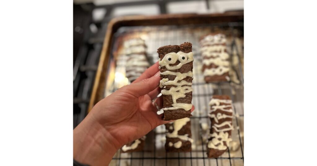 sourdough brownies in front of sheet pan of mummies