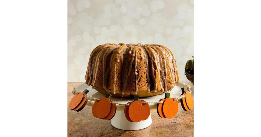 pumpkin bundt cake with pumpkin decor around it.