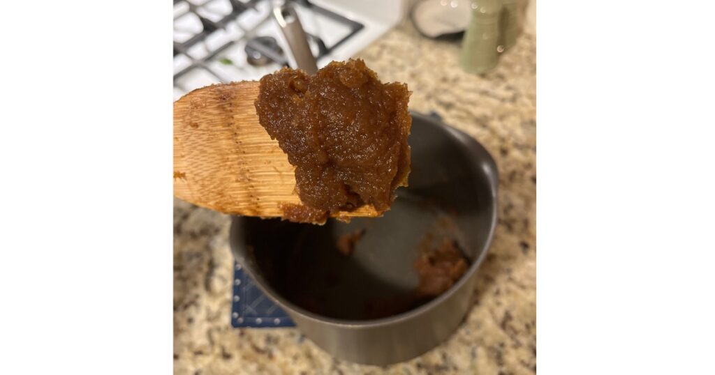 apple butter on wooden spoon