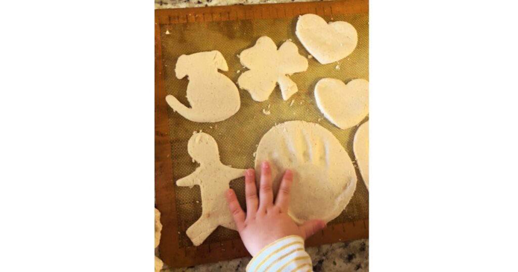 hand next to handprint salt dough ornament