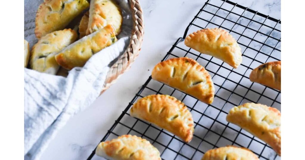 row of hand pies on cooling rack and in basket