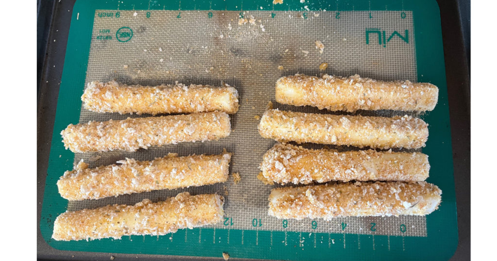 mozzarella sticks on pan in two rows