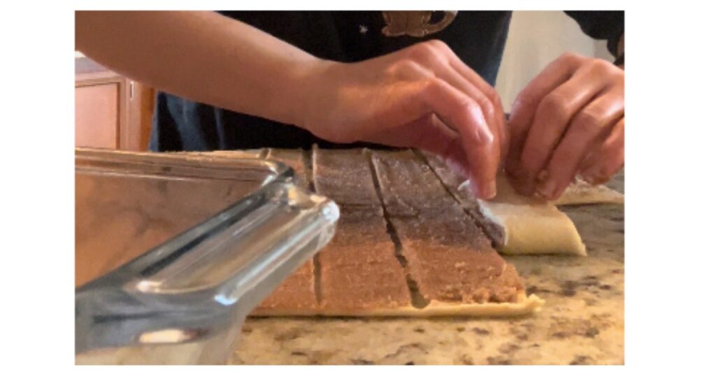 hands shaping cinnamon pull apart bread