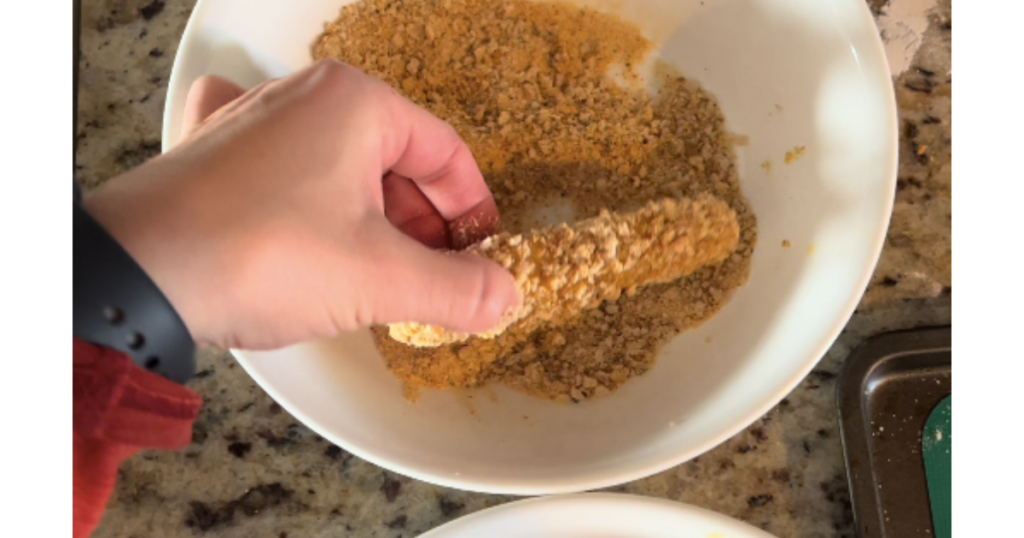 second coating mozzarella stick in sourdough breadcrumbs