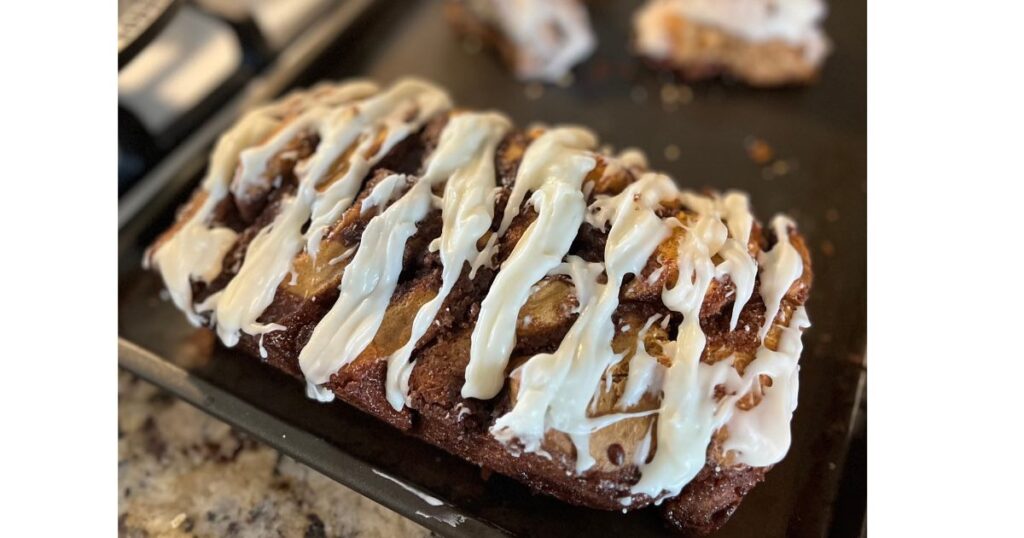 bread with white glaze on baking sheet