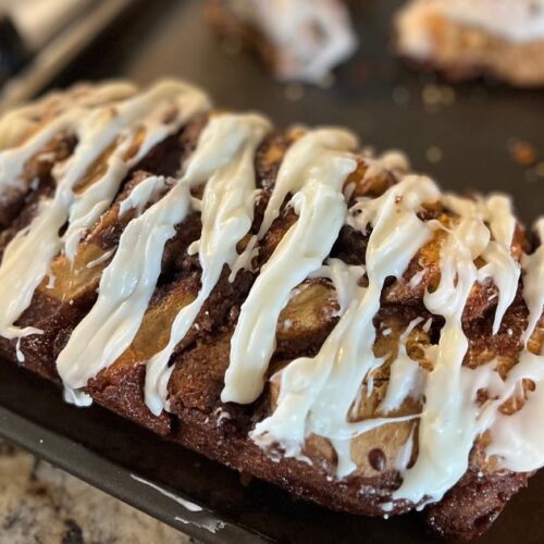 bread with white glaze on baking sheet