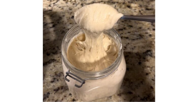 sourdough starter in a jar and on a spoon