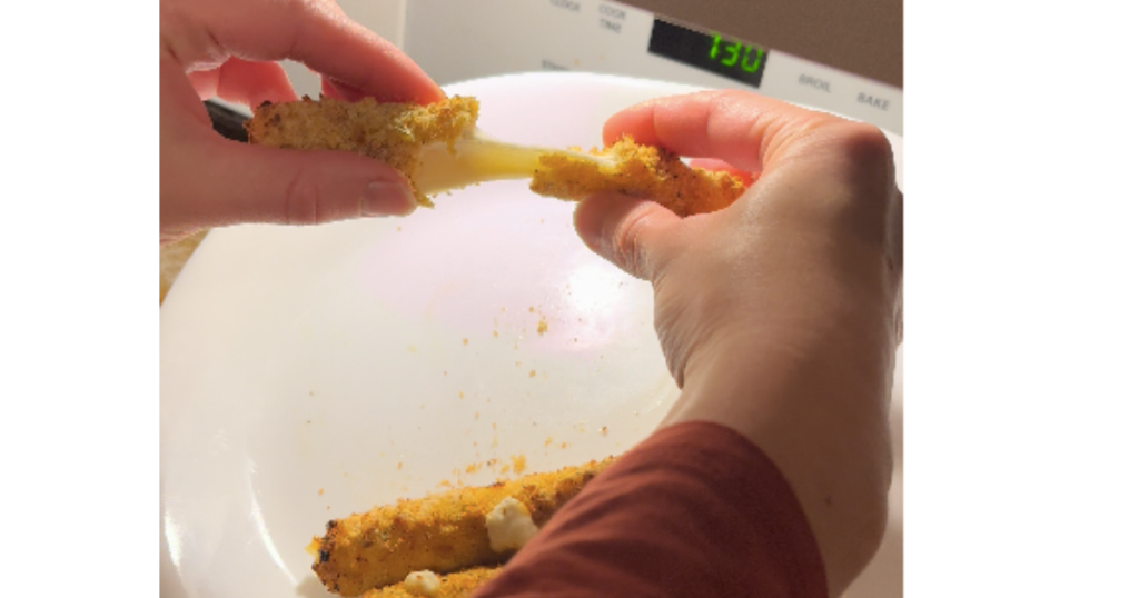 breaking a mozzarella stick with hands