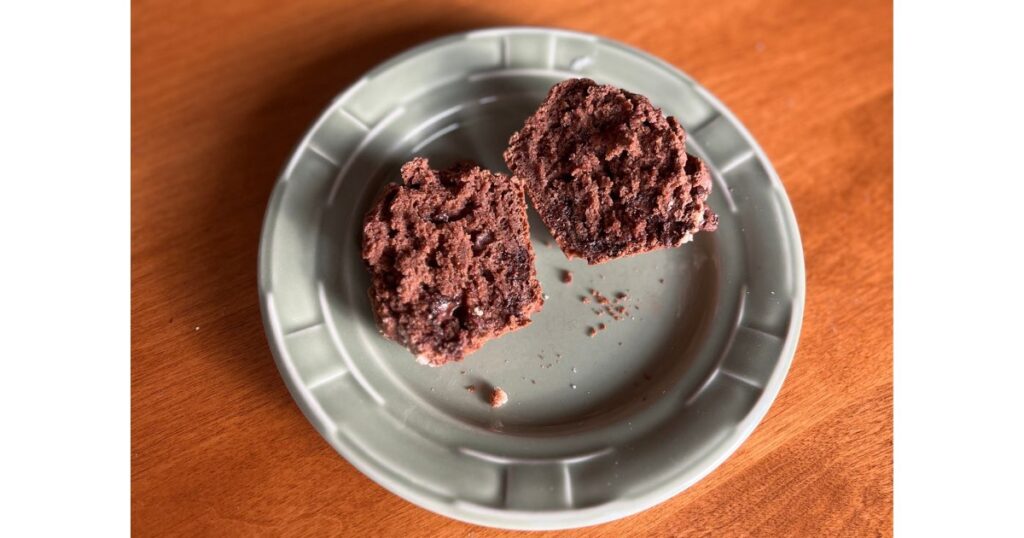 muffin sliced in half on green plate