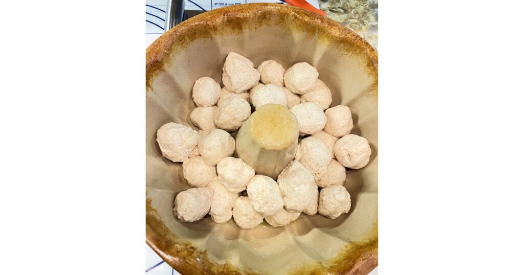 sourdough dough balls in a ceramic pampered chef bundt pan