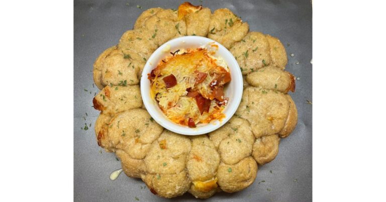 sourdough cheese bread with smoked pizza dip in middle on a baking sheet