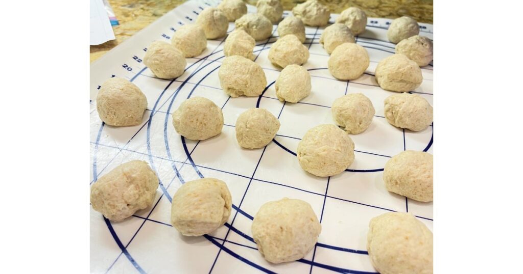 forty sourdough mozzarella balls on a countertop protector