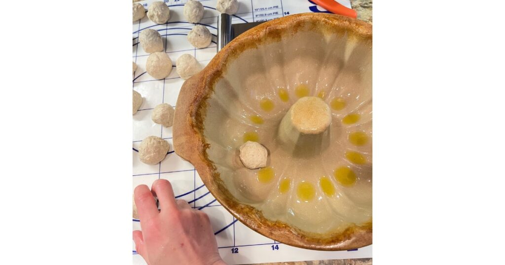 sourdough dough balls in a ceramic bundt pan