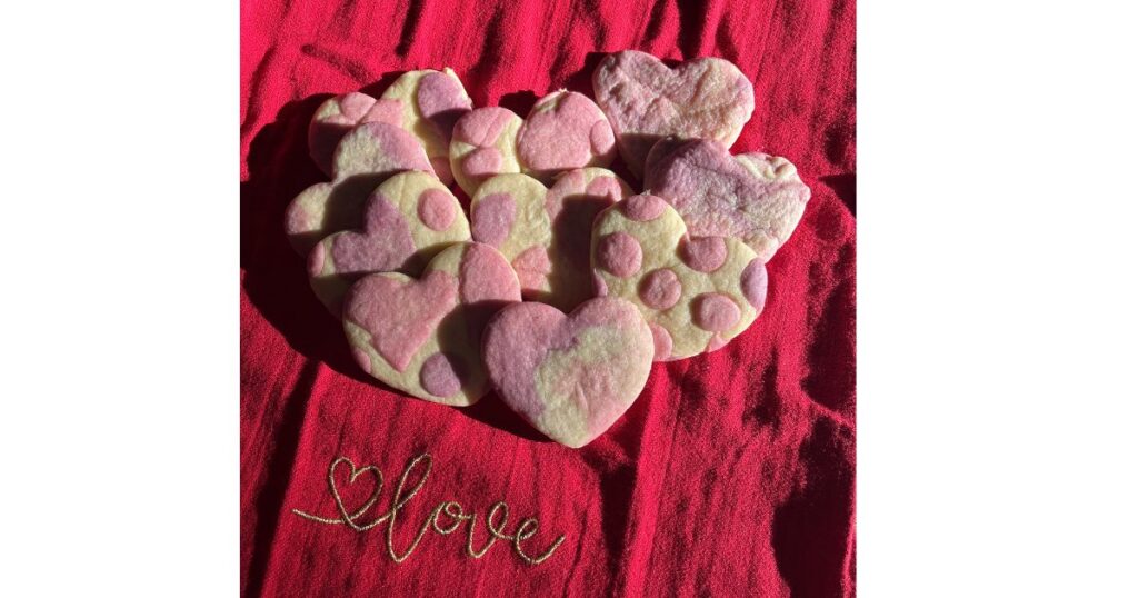 heart shaped sourdough cookies on red background