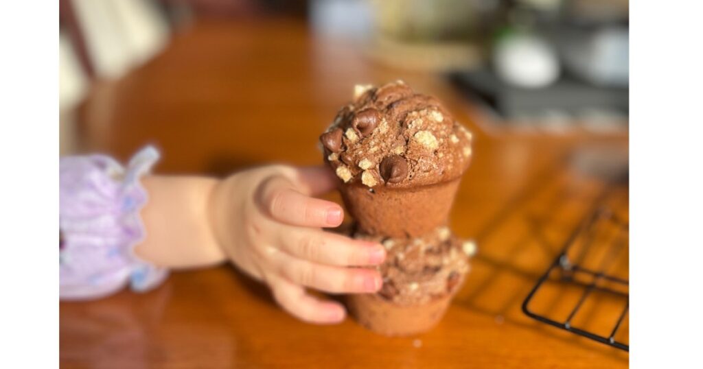 hand grabbing double chocolate chip muffin