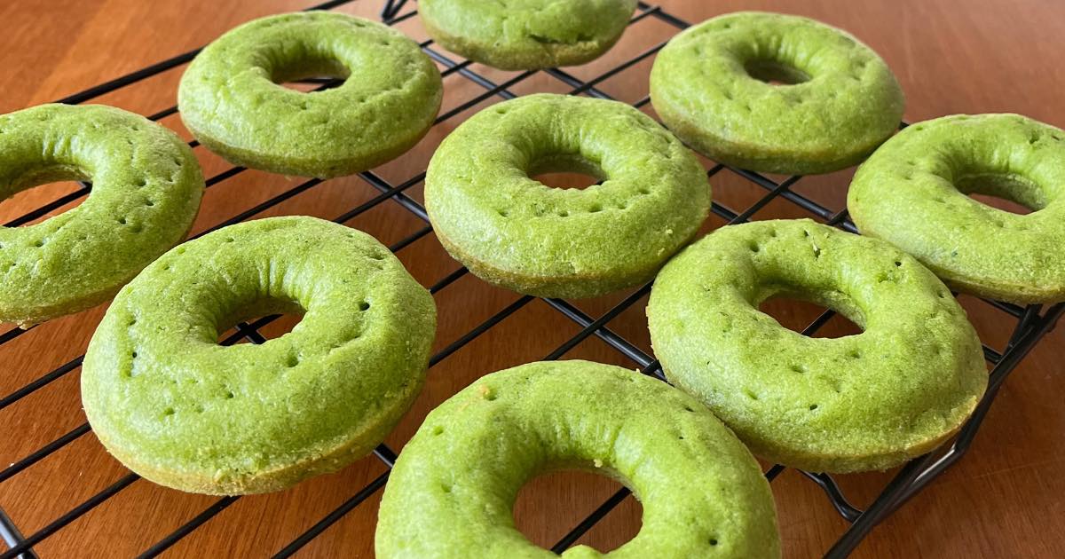 green donuts on cooling rack.