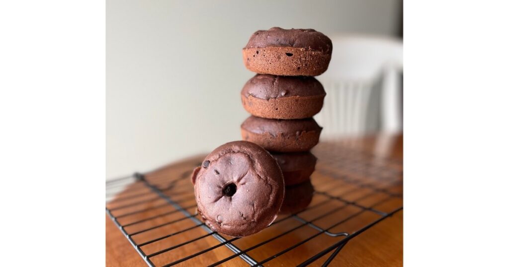 stack of sourdough chocolate donuts on wire rack